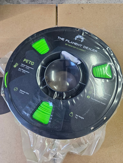 Spool of filament labeled 'The Filament Dealer' on a cardboard background