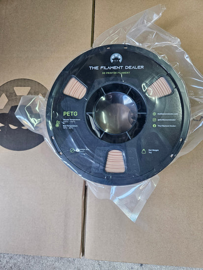 Spool of filament on a cardboard surface