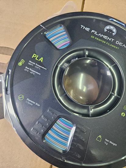 Spool of filament with visible branding on a cardboard background