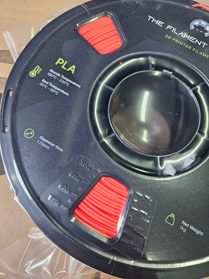 Spool of PLA filament with visible branding and specifications.