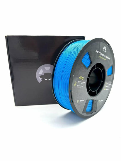 Spool of blue 3D printing filament with a black box in the background