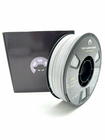 Spool of filament with a black box featuring a logo on a white background