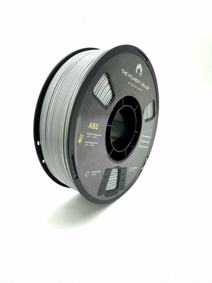 Spool of filament labeled 'ABS' on a white background