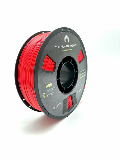 Spool of red 3D printing filament on a white background