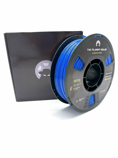 Spool of blue filament with a black box on a white background